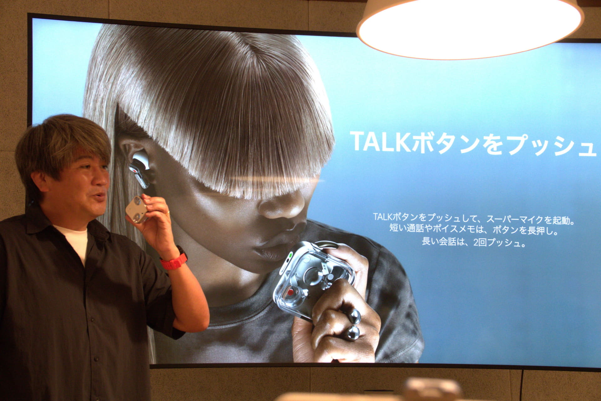 Nothing Japan代表の黒住吉郎氏。スライド上では、かなり近くまでケースを持ってきているが、黒住氏いわく、そこまで近づけなくても大丈夫とのこと