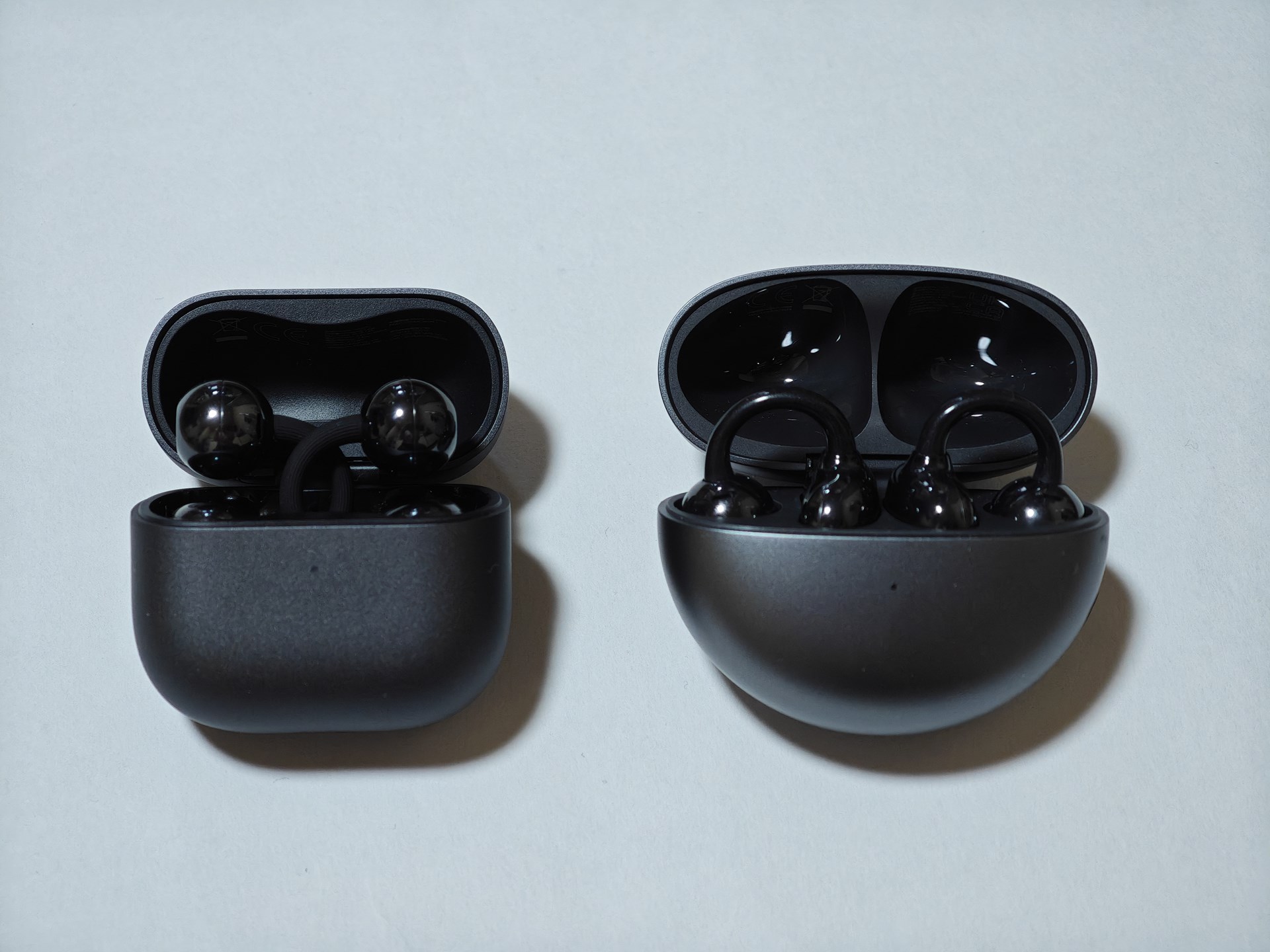 開いた状態。2はイヤホンのブリッジが交差するように入れられています。また、初期化ボタンがケース右側にあります。