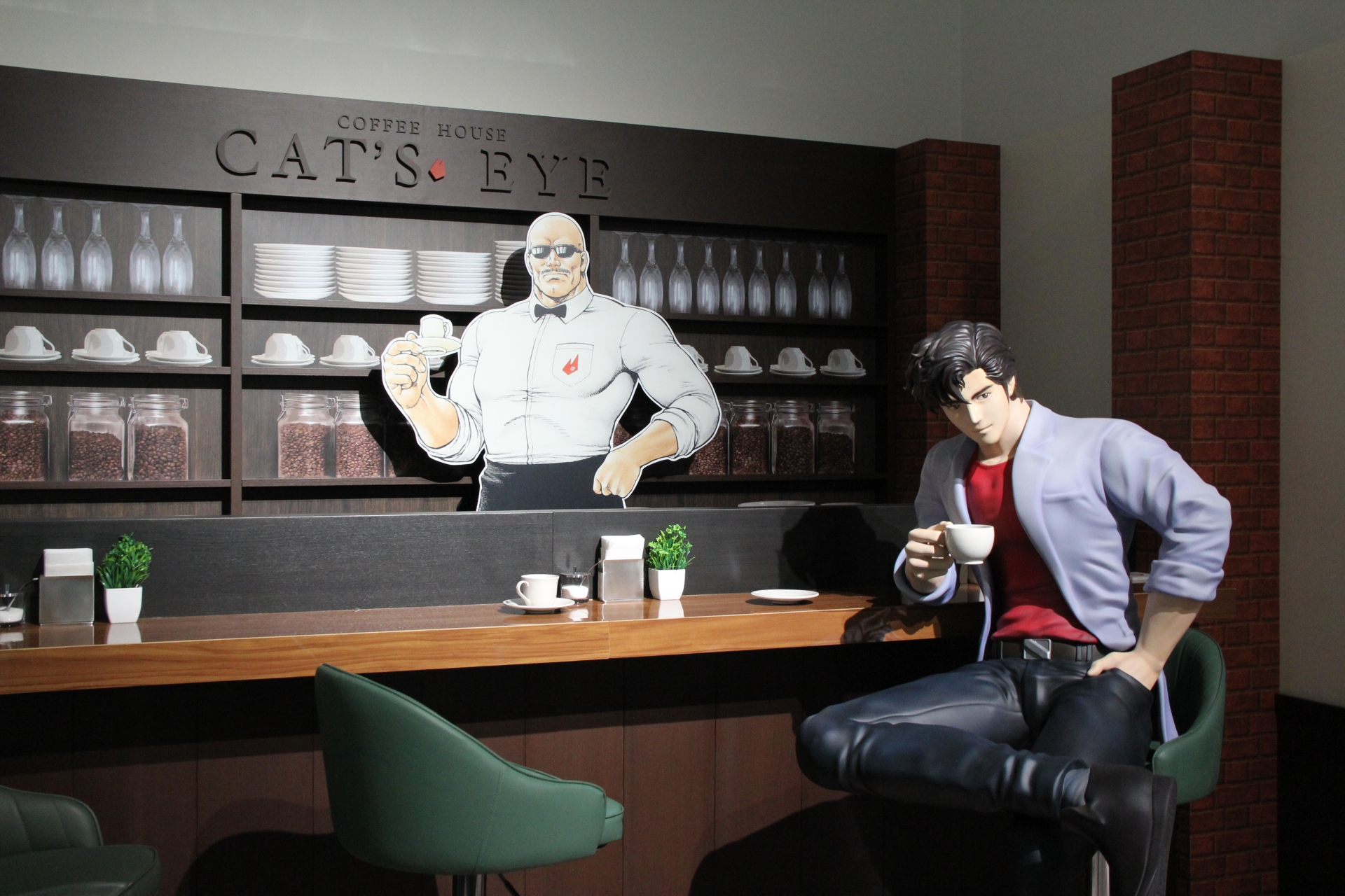 喫茶キャッツアイ付近では、壁もレンガ風に彩られている。近づいてみると分かるのだが、実際の獠と海坊主の大きさに驚かされることだろう。カウンターの反対側には、「シティーハンター」が表紙を飾った「週刊少年ジャンプ」を展示したテーブルと、それに合わせて喫茶店風の椅子が置かれている