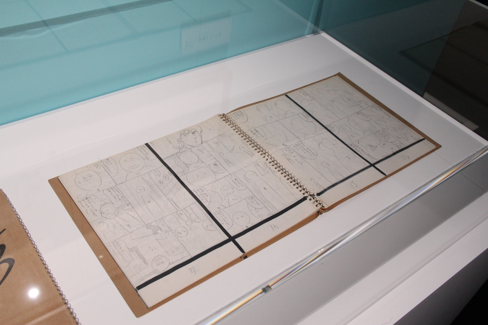 スケッチブックに描かれた下描きと、実際に原稿として完成した状態のページを見比べることができる展示も