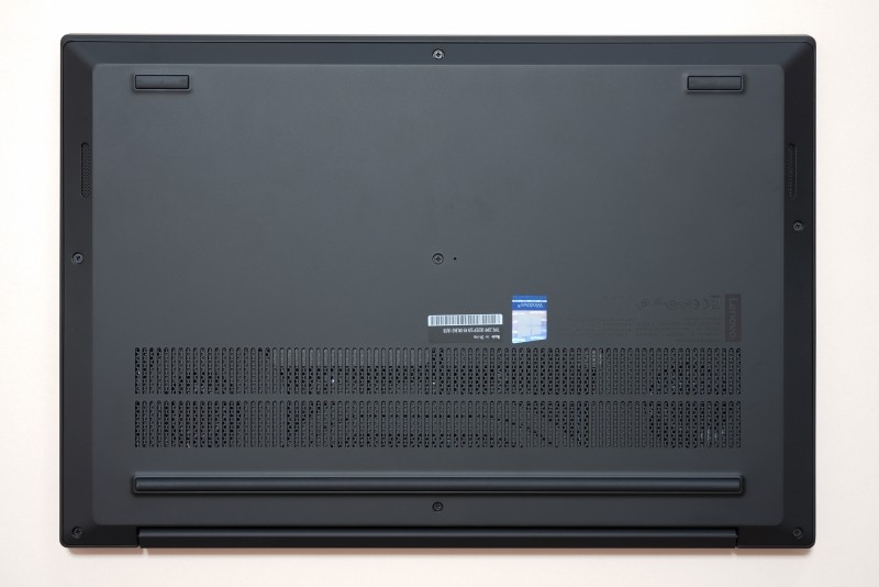 本体底面(下がヒンジ部)。ヒンジ部からは下側に向かって熱気が排気されるが、長いリアラバーフットが吸気口に回り込むのを防ぐ設計。中央やや右の小さな穴は緊急用リセットスイッチだ