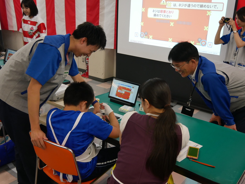 神門社長(右)も参加者の作業を見守る