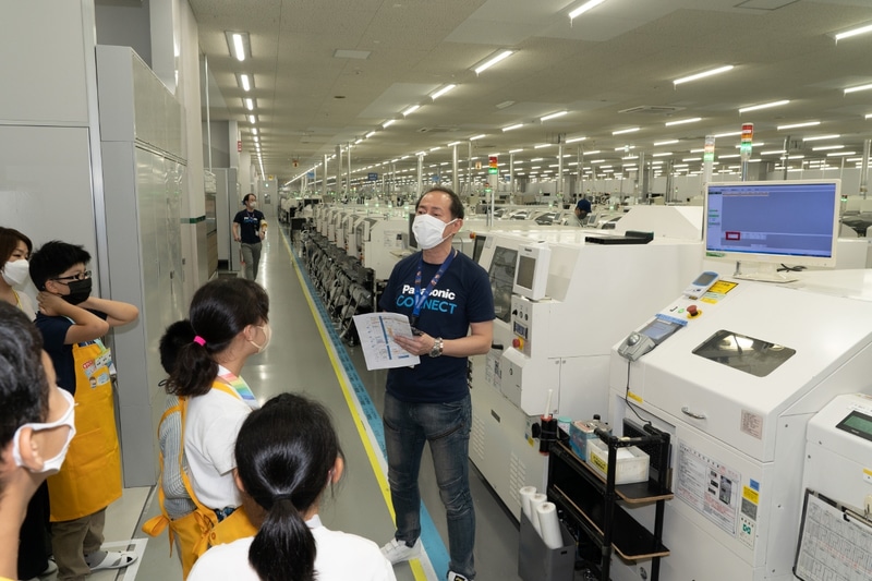 マザーボード基板の実装工程を見学している様子