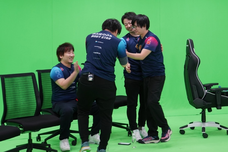 2巡目大将戦に勝利し、グランドファイナル進出を決定したたふ～どを迎えるチームメンバーたち