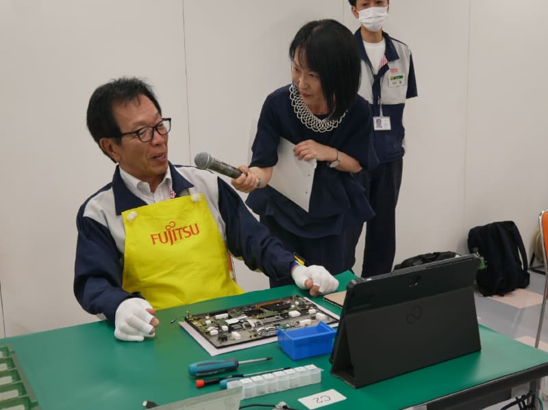 途中経過について、MCを務めたフリーアナウンサーの山岡ゆり子さんから直撃インタビューを受ける齋藤会長。「思ったより難しい。匠の技術をヒシヒシと実感した」とコメント