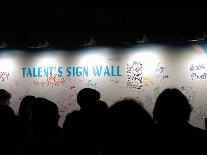 所属タレントのサインウォール。推しのサインにスマホを向ける来場者で賑わっていた
