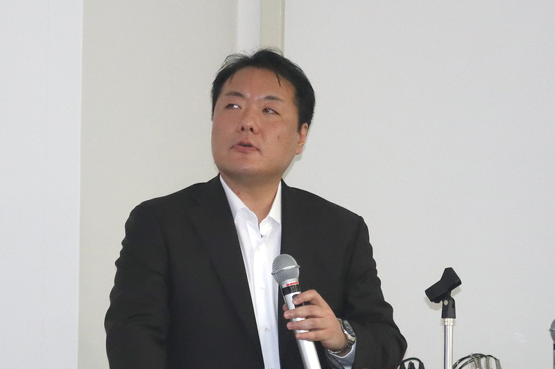 事前説明会においてAI Plus Bizの開発について紹介したNECパーソナルコンピュータSolution Development Groupシニアマネージャーの丸山亮氏