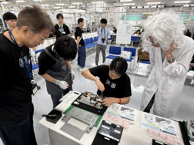 作業を心配そうに見守る神戸工場の遠藤工場長(左)とレッツ博士(右)