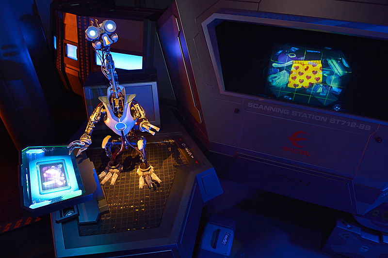 荷物チェックドロイドのG2-9Tが流れて来る荷物の中をスキャン（提供：オリエンタルランド）