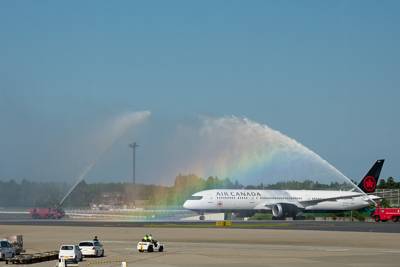 歓迎放水で迎えられるバンクーバー発初便のAC005便。虹がかかる美しいウォーターアーチをくぐって駐機場へ向かった