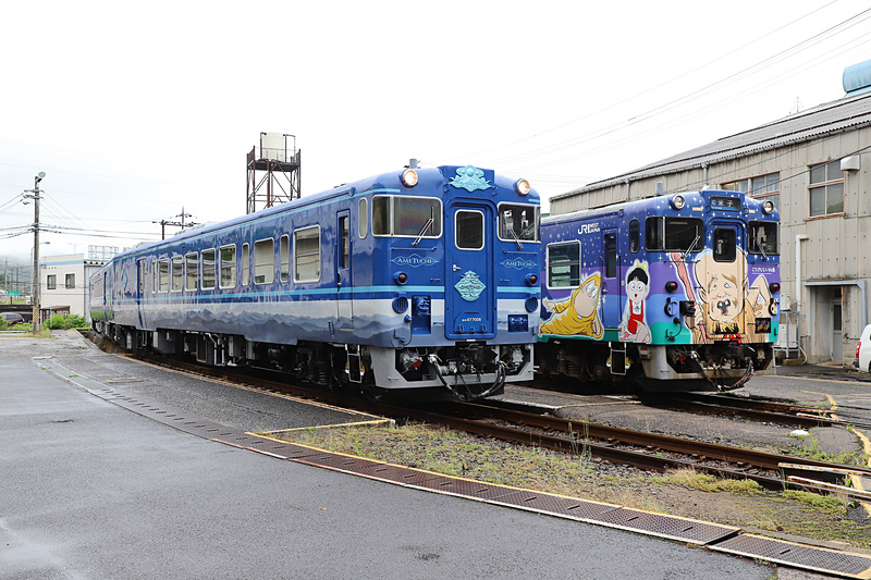 撮影時は曇天のため深い青に見えたが、晴天だと異なった趣になりそうだ。隣に停車しているのは境港線 鬼太郎列車「子泣き爺車両」