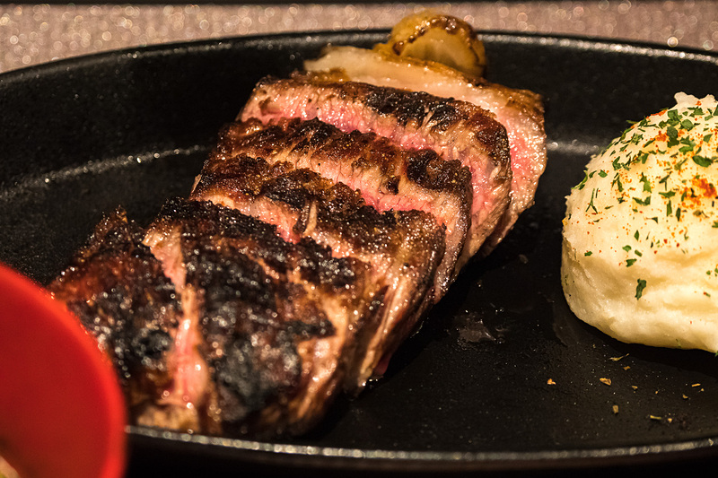 キッチンで豪快に薪焼きされるステーキ