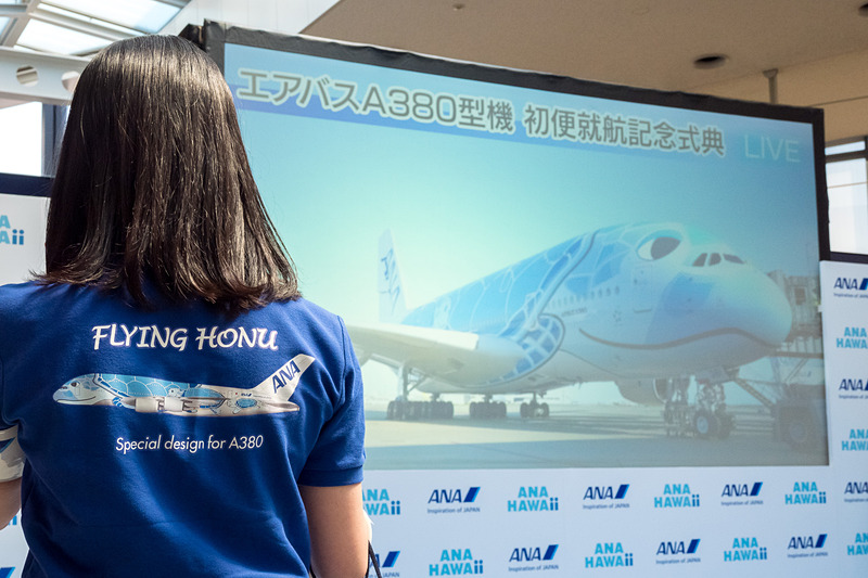 エアバス A380型機就航に合わせて行なわれた記念セレモニー会場。ANAスタッフもFLYING HONUシャツを着用。隣のゲートを使用したので、スクリーンでは機体をライブ中継した