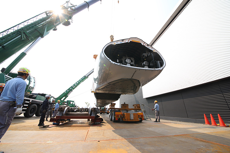 トレーラーの台車を移動させるため、新幹線車両を吊り上げる