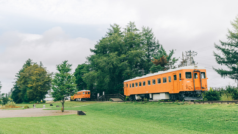 幸福駅で待っていたのは、旧国鉄・広尾線のオレンジの車両。訪れた旅行者の名刺が大量に貼り付けられた旧駅舎はインパクト大