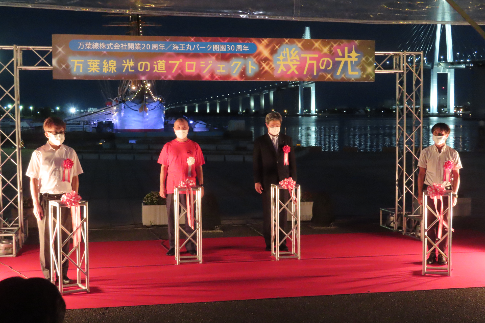 点灯式には万葉線の中村正治社長（中央左）、射水市の夏野元志市長（中央右）が参列