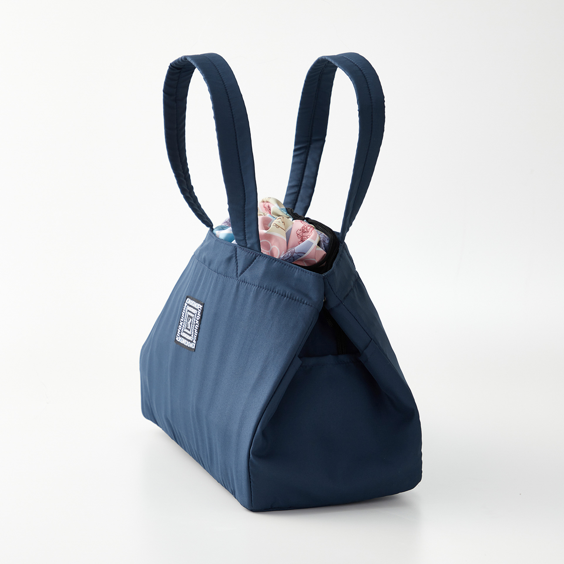 両サイドにポケット、ボタンを留めるとフォルムチェンジでコンパクト化