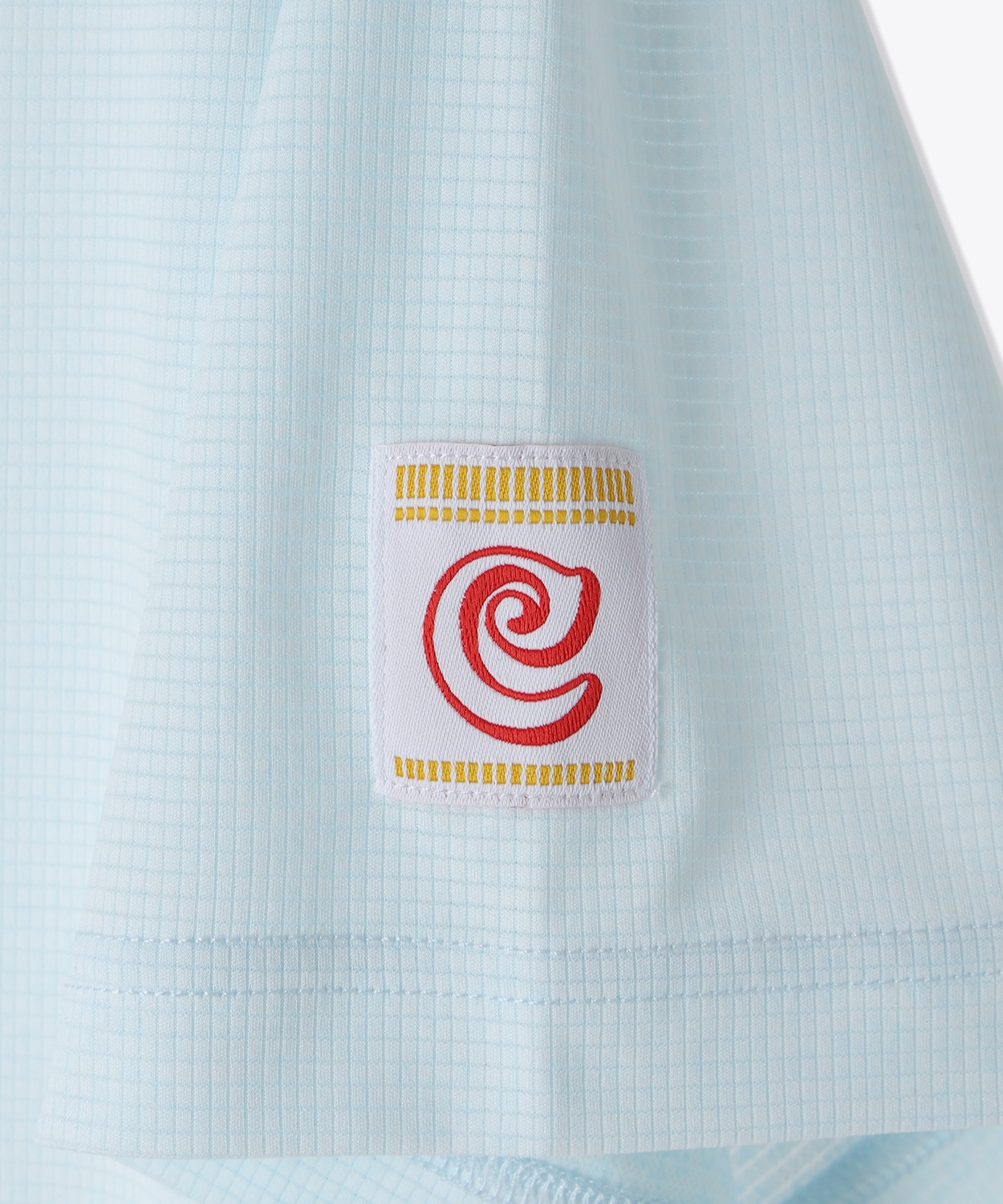 カップヌードルのパッケージ風にコロンビアの「C」を表記した左袖のタグ