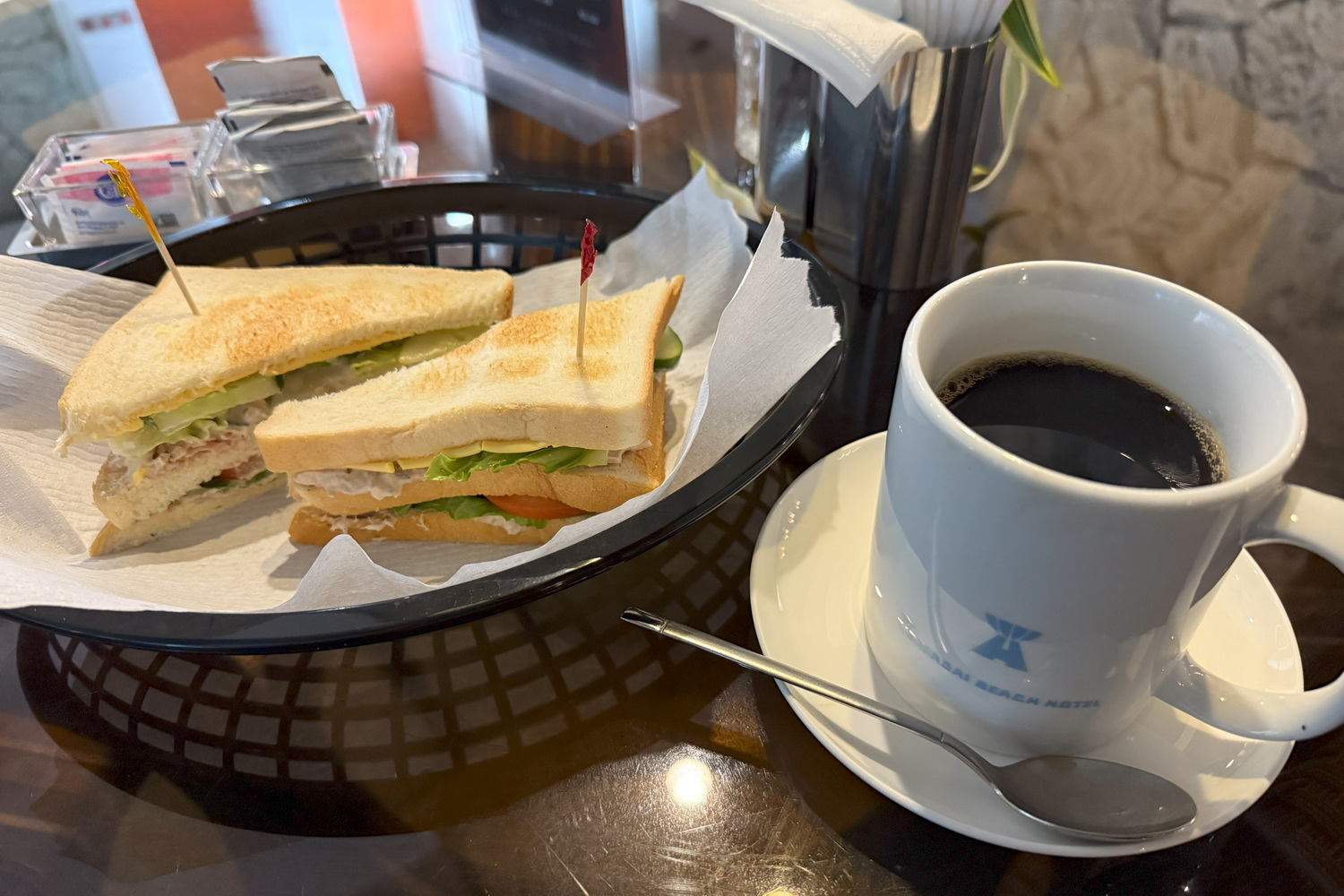 アイリでいただいたサンドイッチとコーヒー（11ドル）。軽く済ますつもりだったが、トースト3枚分の具たっぷりなホットサンドだった。サイパンの食事はボリューミー