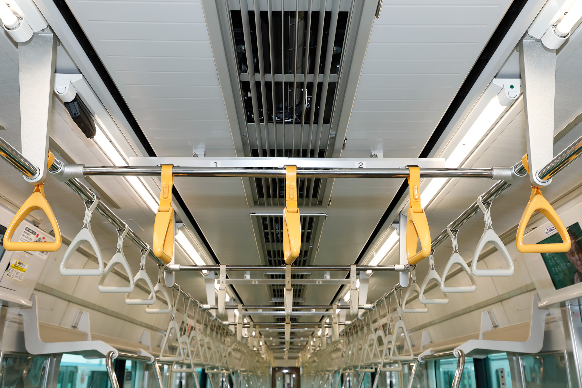 4・5号車の天井まわり。吊手の形状が異なるほか、側壁の色が、リニューアルされたほかの車両と比べていくらか濃い様子が見て取れる