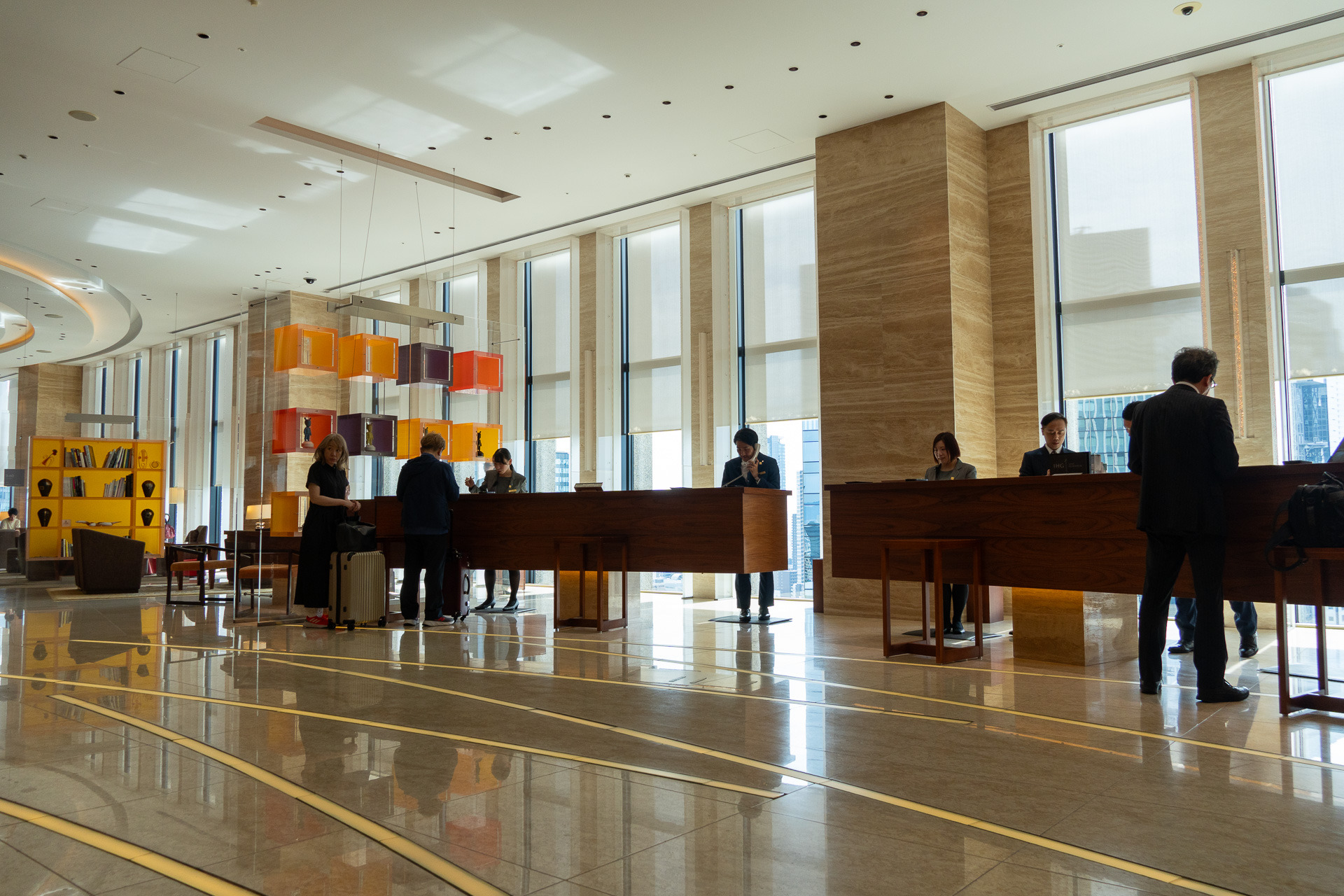 The grand, open-plan 20th-floor lobby. The front desk is directly ahead as you exit the elevator.