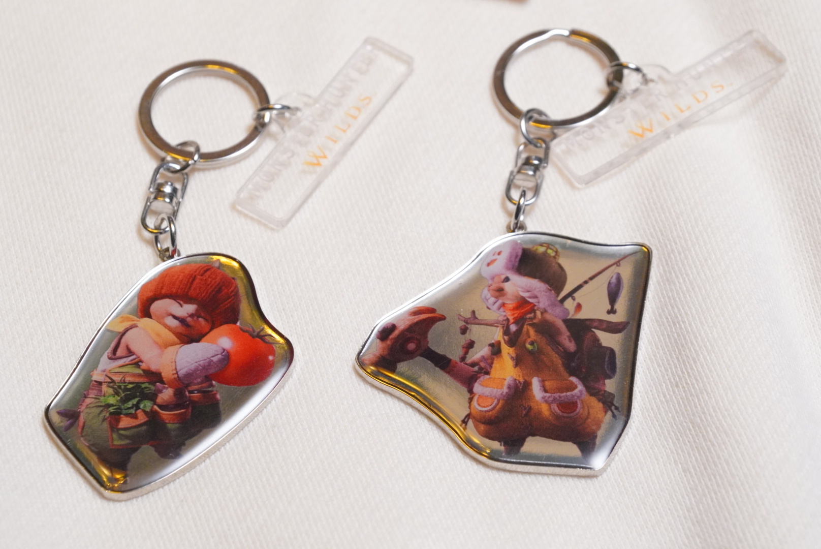 The keychain set pairs a Palico with Tom from the support unit.