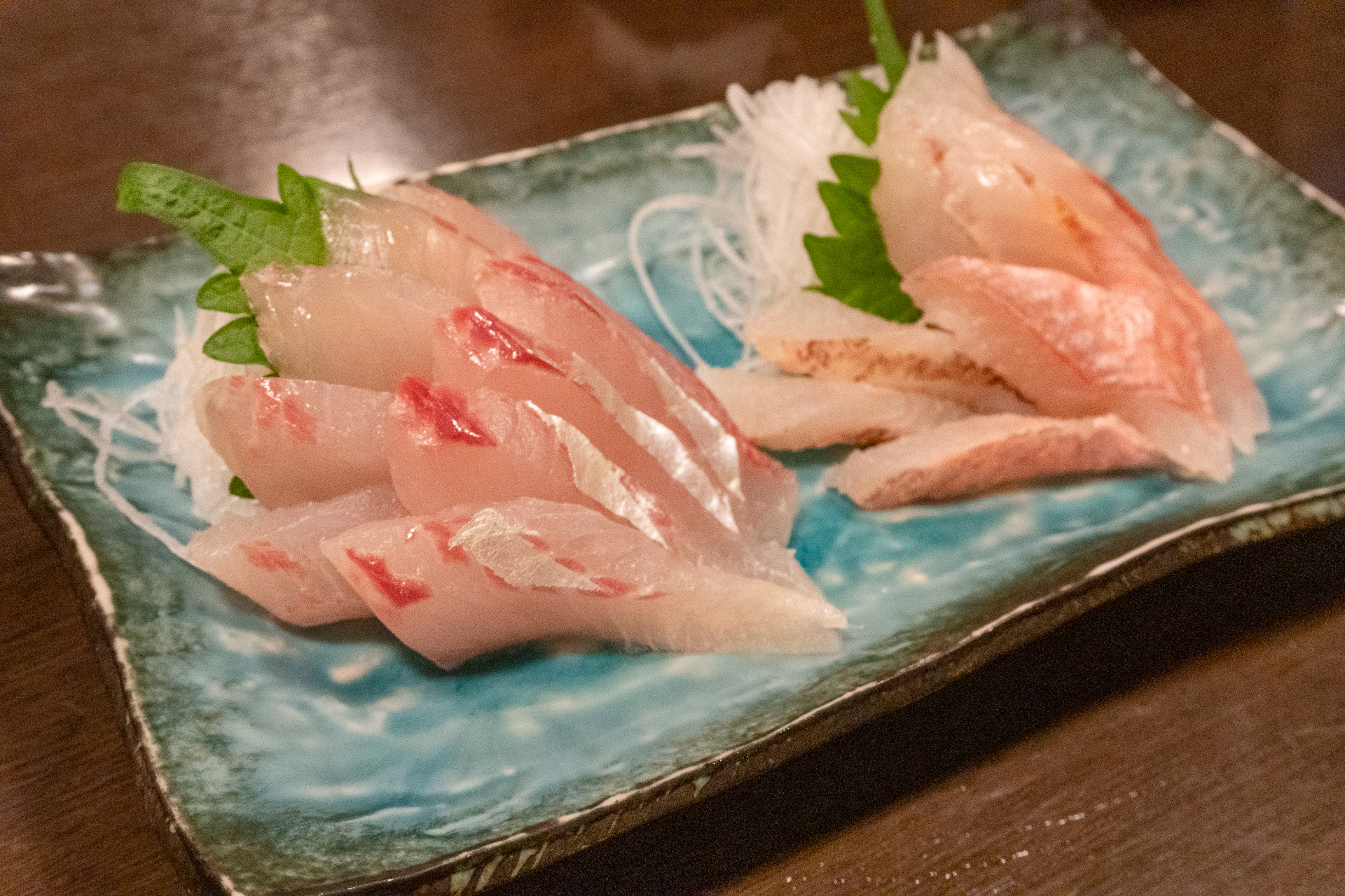 釣った魚を持ち込むと、お店の人が捌いてお刺身にしてくれます。写真は昼間釣ってきたばかりのオジサン（左）とシマアジ（右）