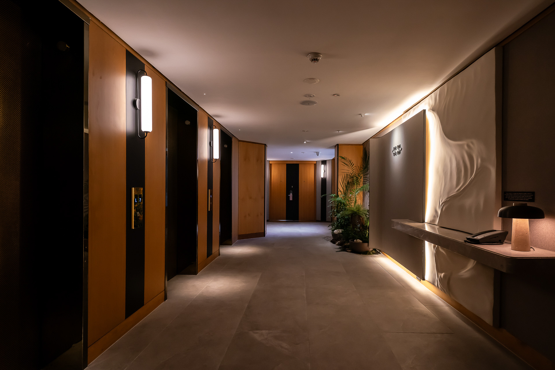 客室のエレベーターホールは暗めで落ち着いた作り