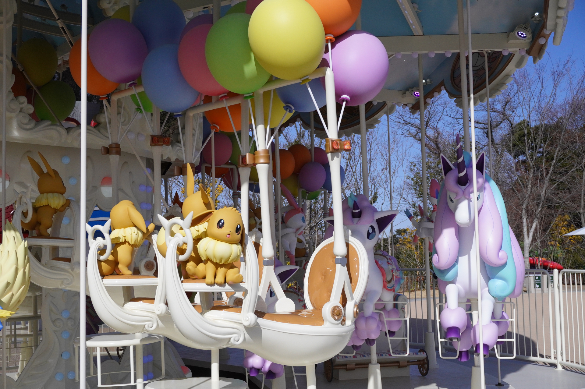 The "VeeVee Voyage" carousel, where the dream of riding a Rapidash comes true. It's surrounded by Eevee, Vaporeon, Jolteon, Flareon, Espeon, Umbreon, Leafeon, Glaceon, and Sylveon.