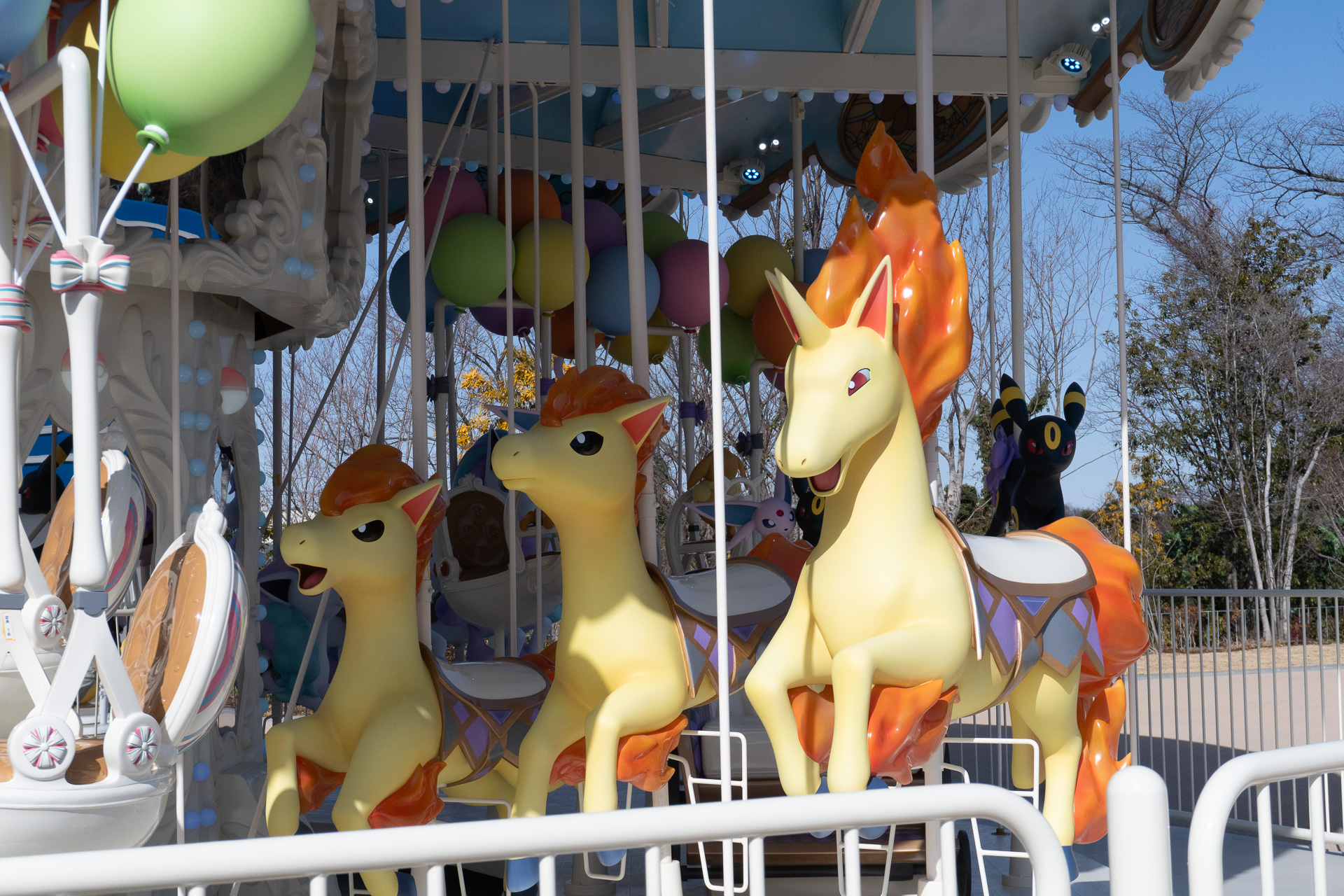 The "VeeVee Voyage" carousel, where the dream of riding a Rapidash comes true. It's surrounded by Eevee, Vaporeon, Jolteon, Flareon, Espeon, Umbreon, Leafeon, Glaceon, and Sylveon.
