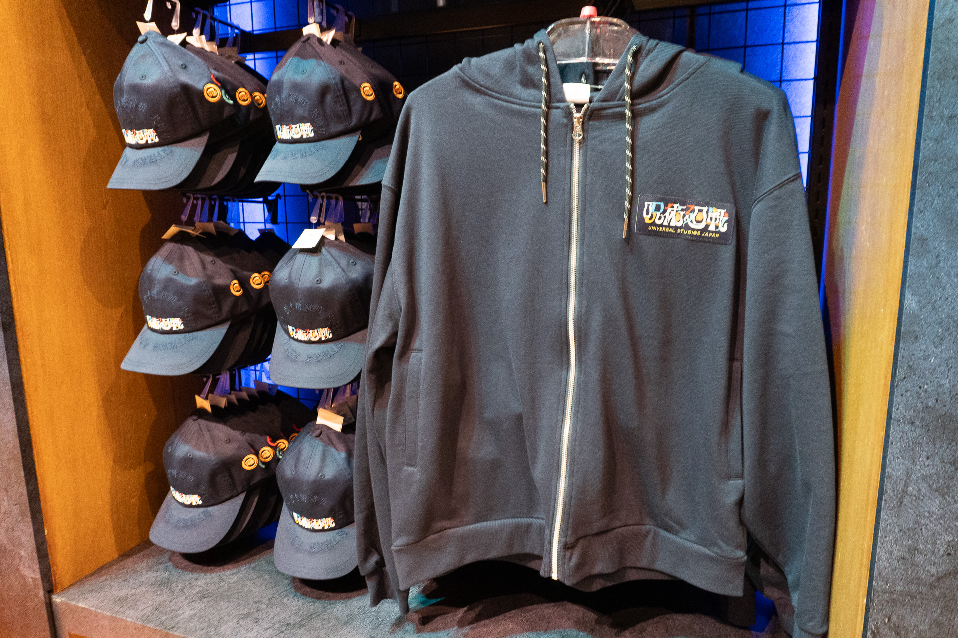 The parka (¥7,800) features designs of Cursed Techniques like Itadori's "Black Flash" and has a striking Jujutsu High school crest on the back.