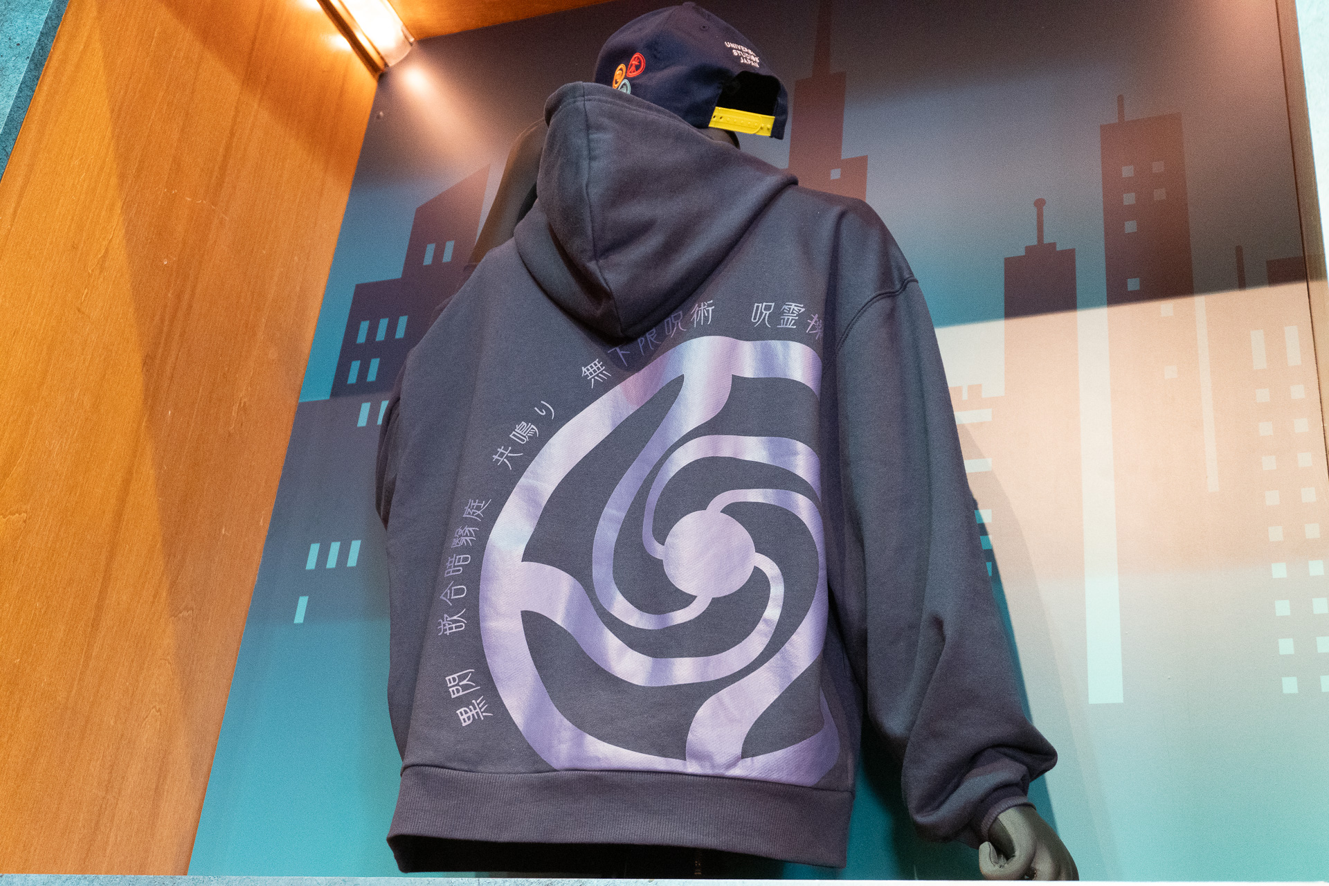 The parka (¥7,800) features designs of Cursed Techniques like Itadori's "Black Flash" and has a striking Jujutsu High school crest on the back.