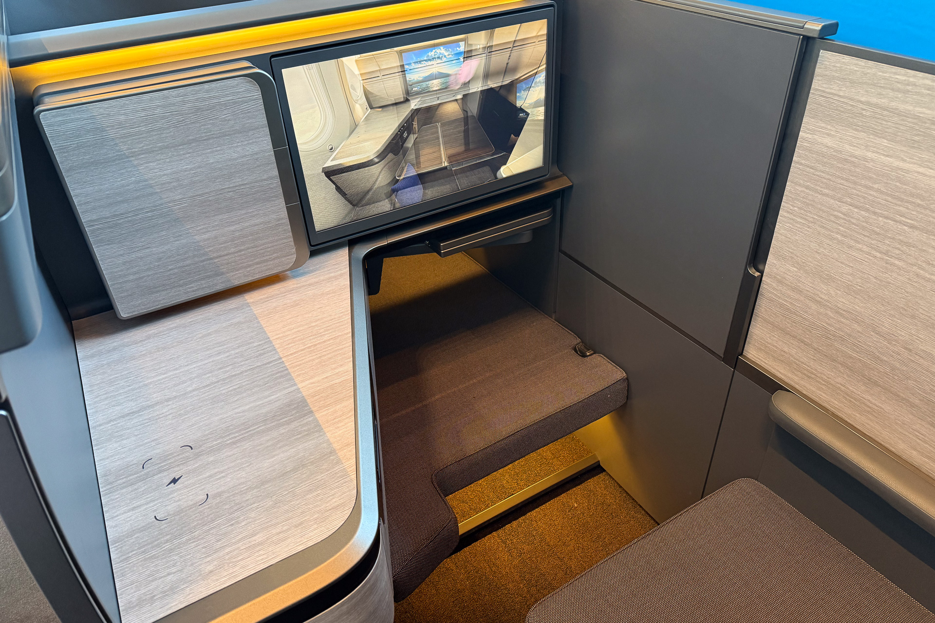 An interior view of the suite in the seated position, featuring a 24-inch personal monitor.