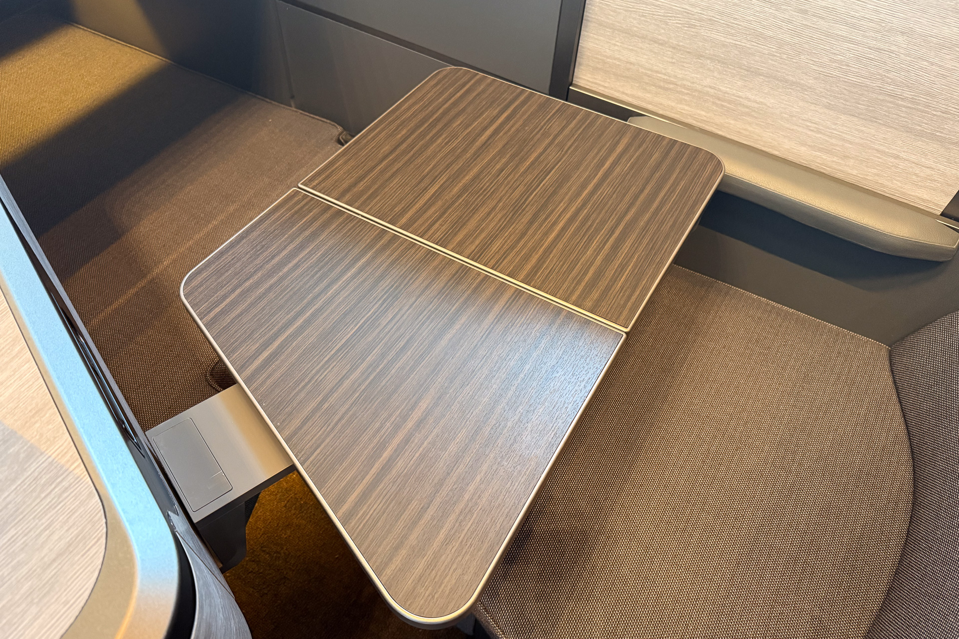 The foldable table slides out from beneath the monitor.