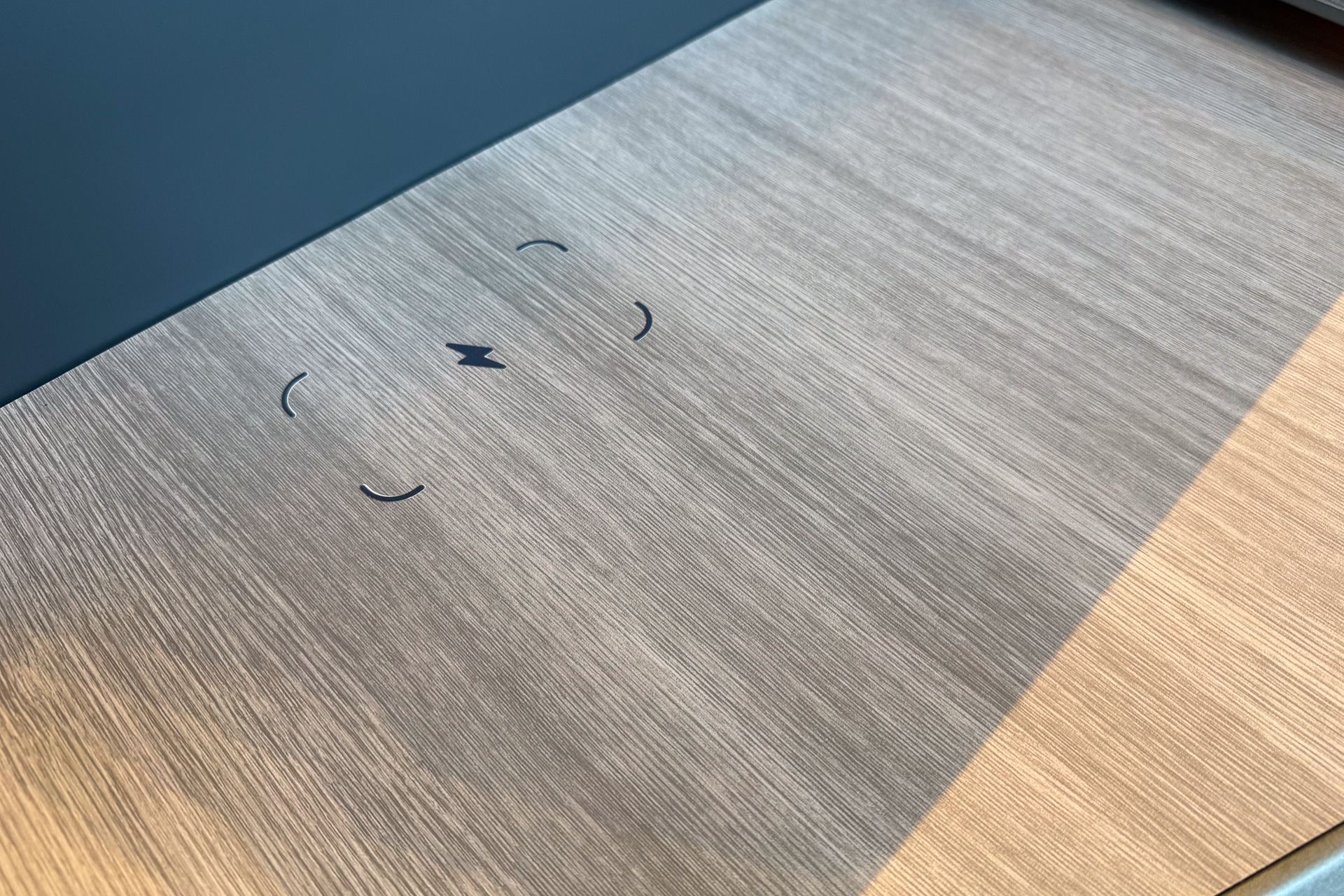 The side table includes a wireless charging pad, a first for ANA.