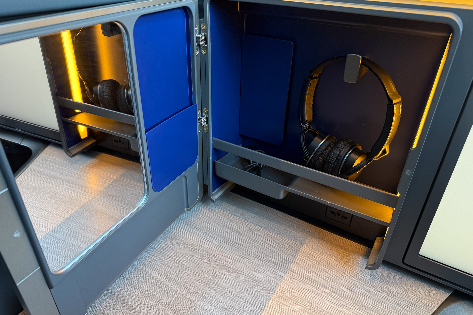 A storage compartment holds the headphones.