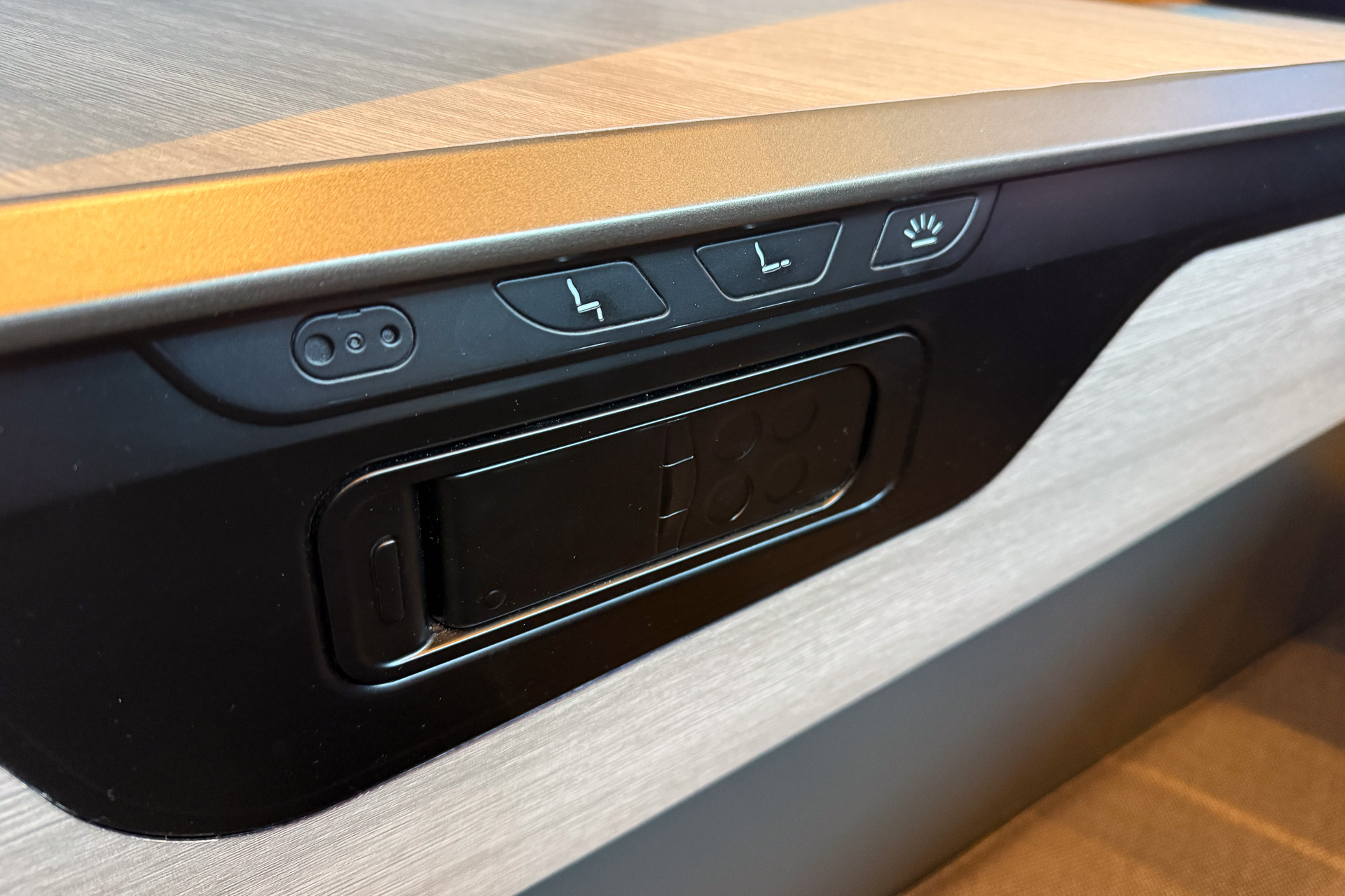 Seat adjustment controls and the handset for the personal monitor.