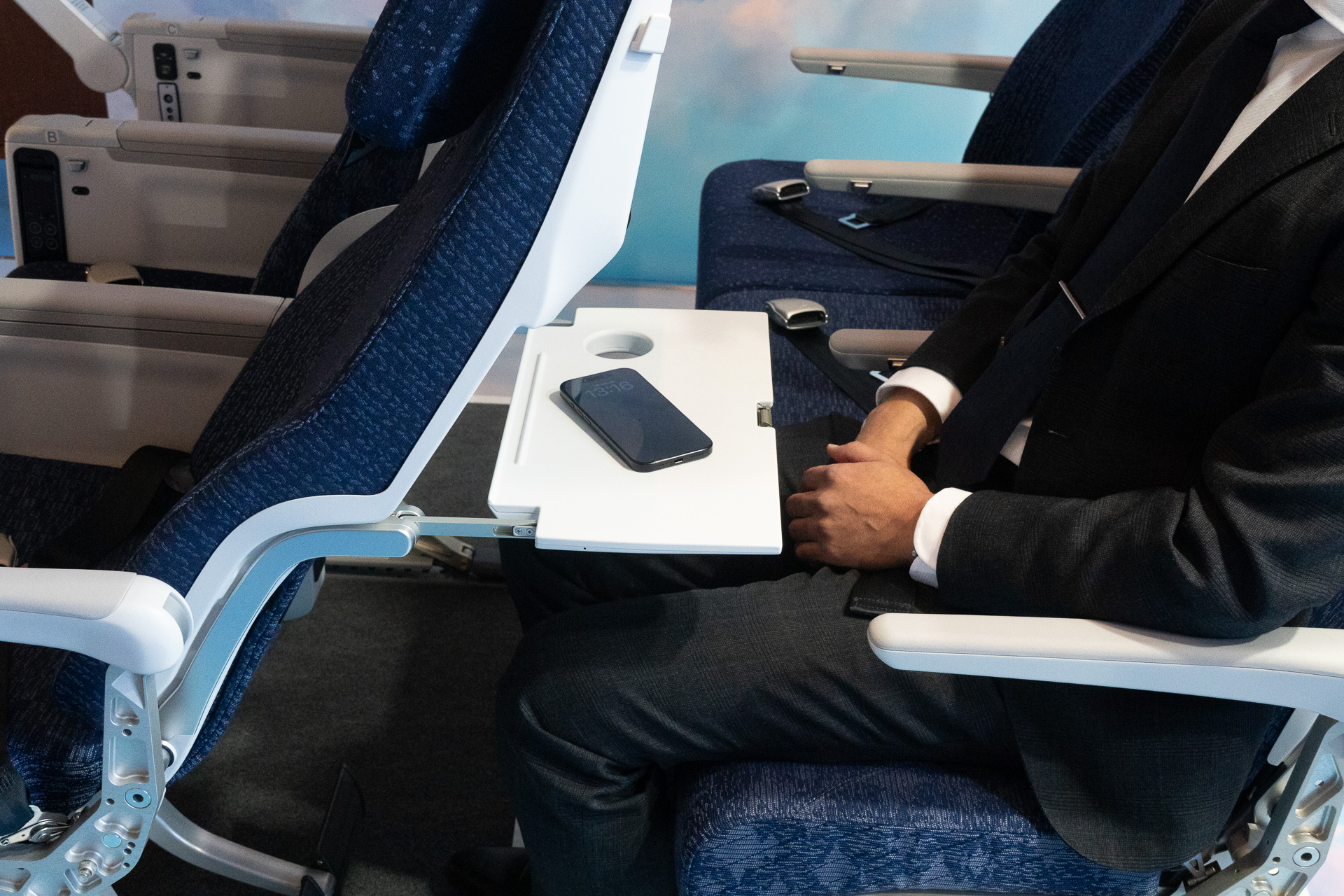 The tray table is slightly shallow but features a non-slip surface and a dedicated cup holder.