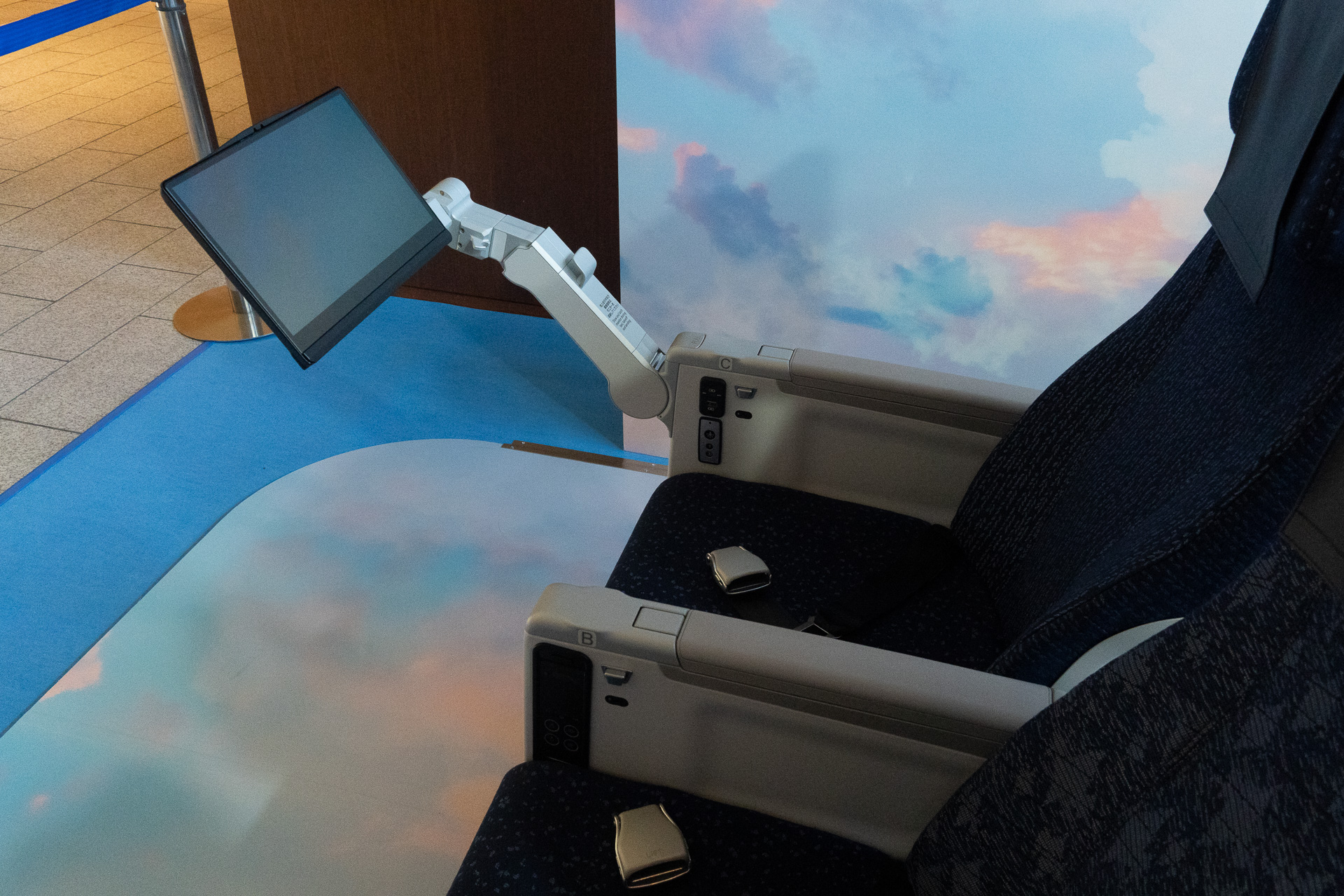 In bulkhead seats, the monitor extends from an armrest.