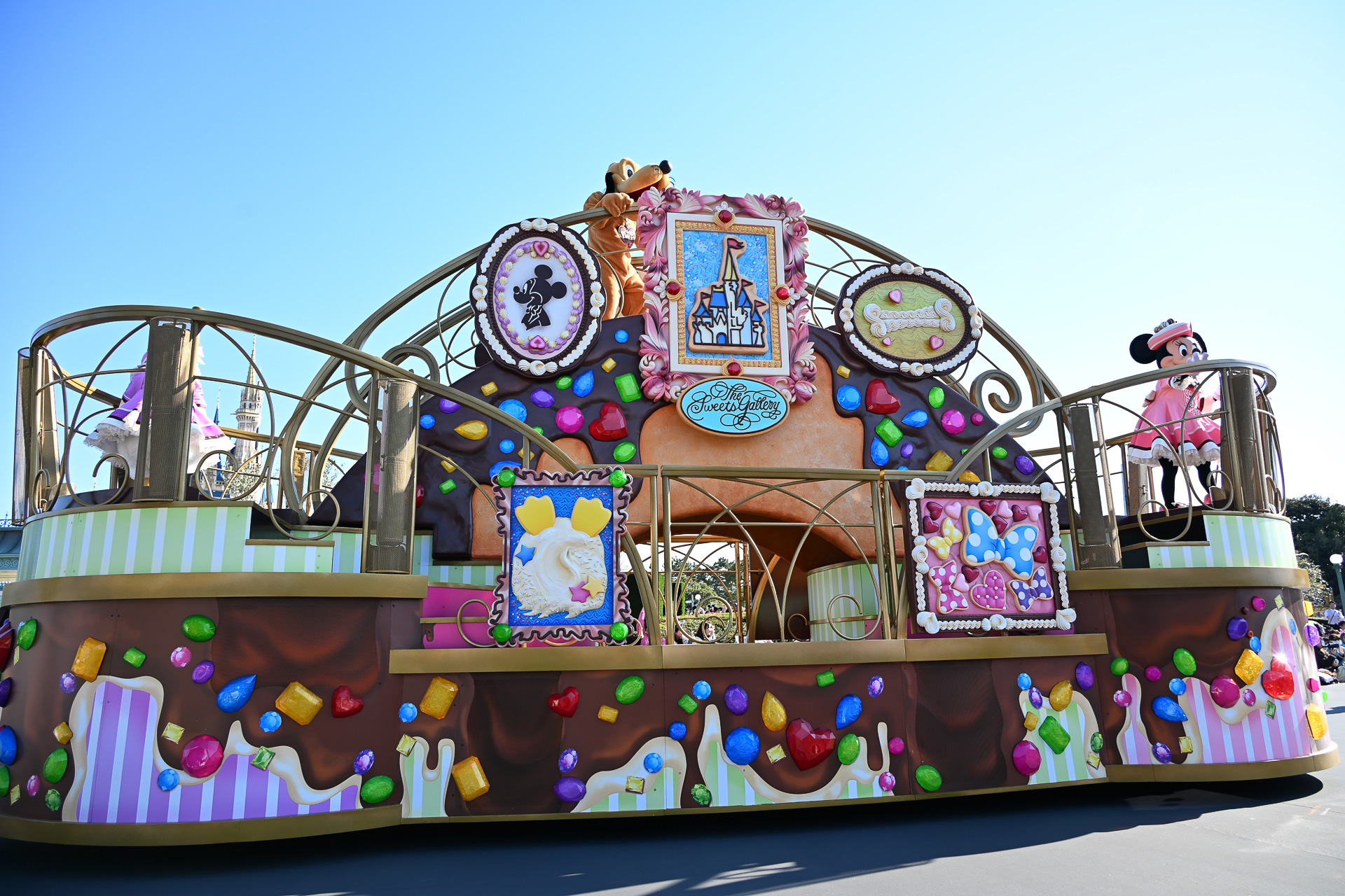 チョコレートやマカロンで彩られたガイドの衣装で、お菓子で作られた芸術作品を紹介