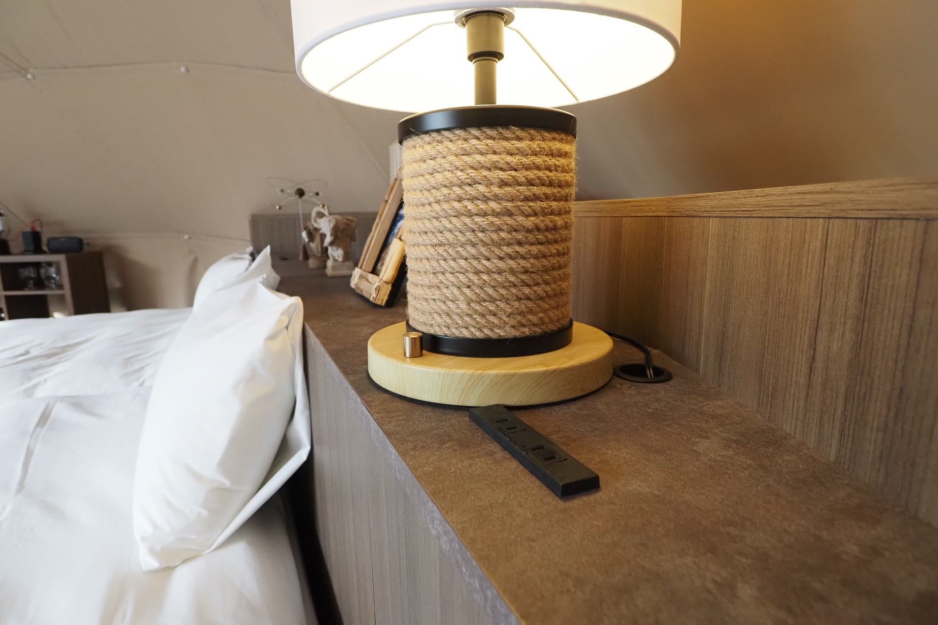 ベッドのヘッドボードには2か所の電源コンセント。入口の横のテーブルにはコールマンのランタンと充電ステーション