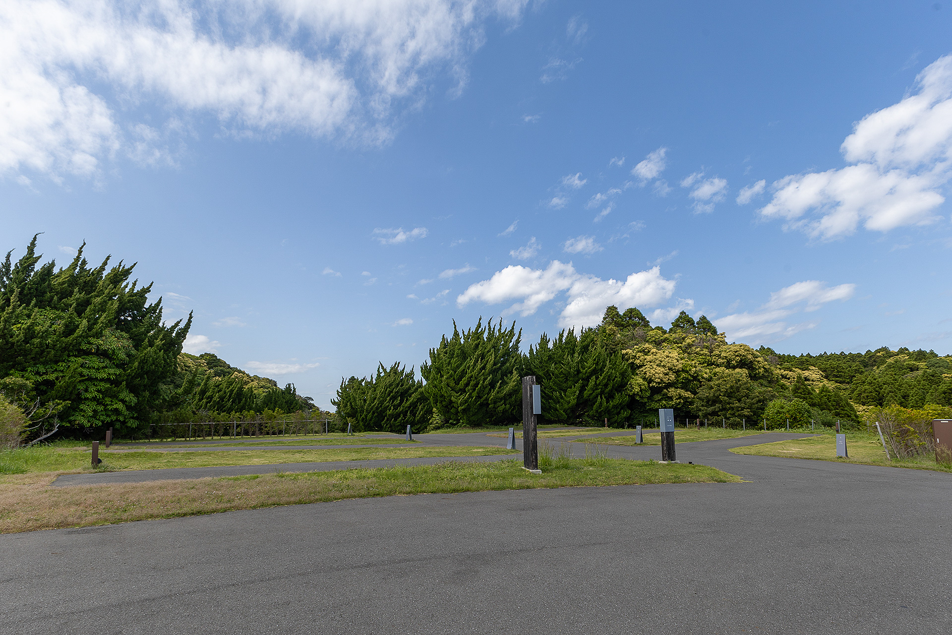 RVパークの全景。撮影位置は管理棟前の道路。中央の通路を挟んで両側に3つずつ区画を設けている。その奥はテント泊キャンプエリア