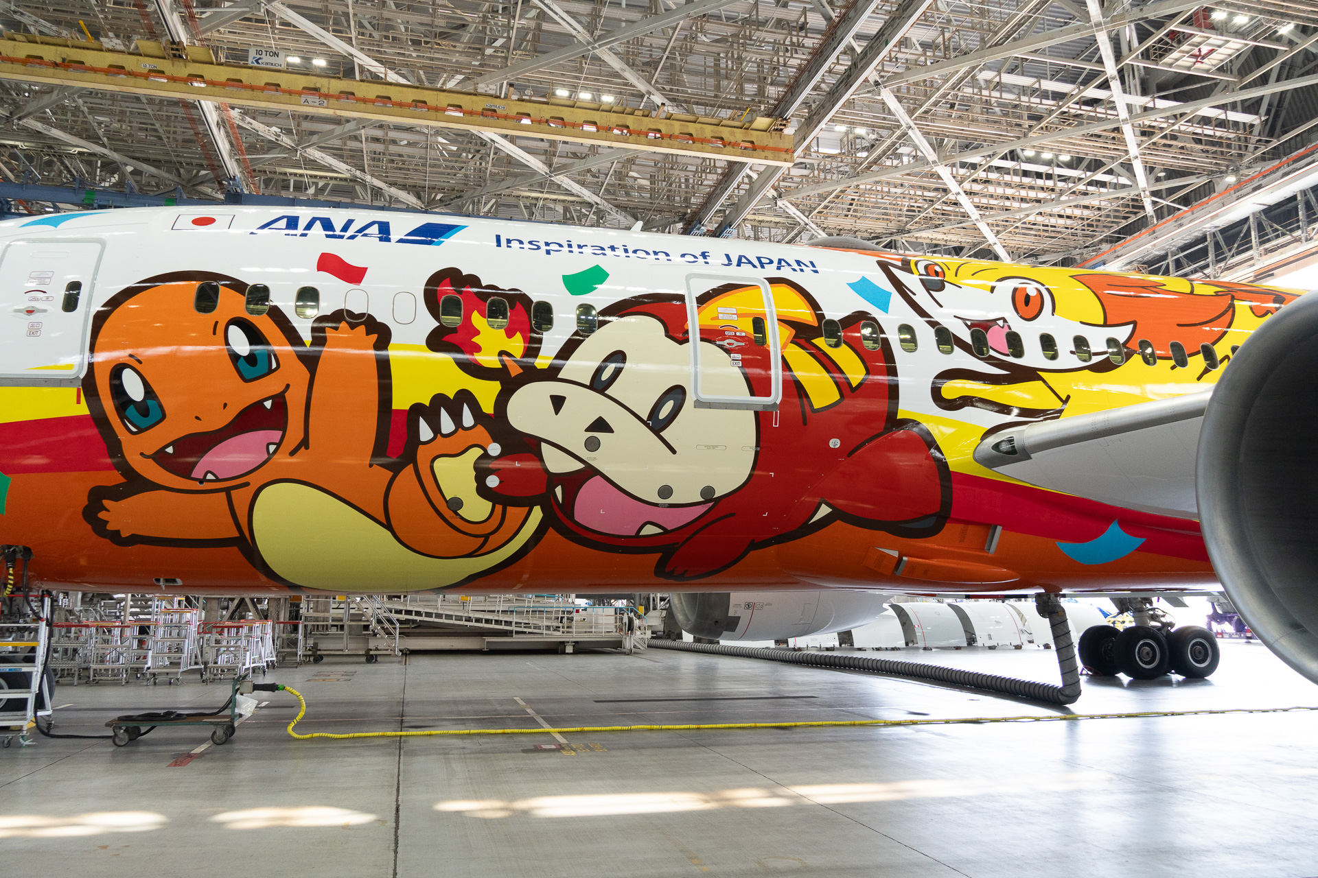 The left side of the "Pokémon Jet Red," from front to back: Charmander (Red/Green), Fuecoco (Scarlet/Violet), Fennekin (X/Y), Torchic (Ruby/Sapphire), Pikachu, and Pomuken (Wind/Wave).