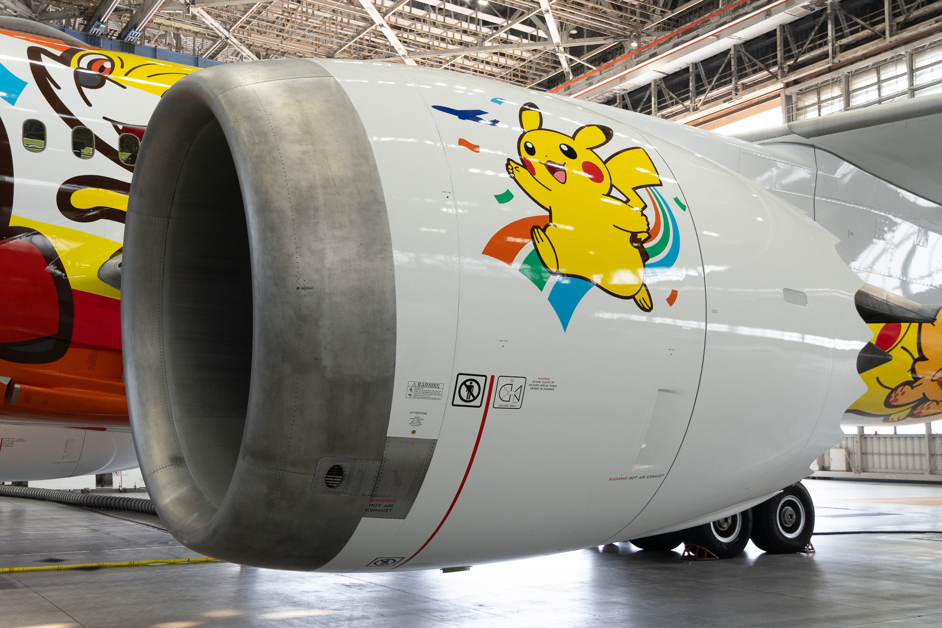 A dynamic illustration of Pikachu appears to be dashing across the engine cowling.