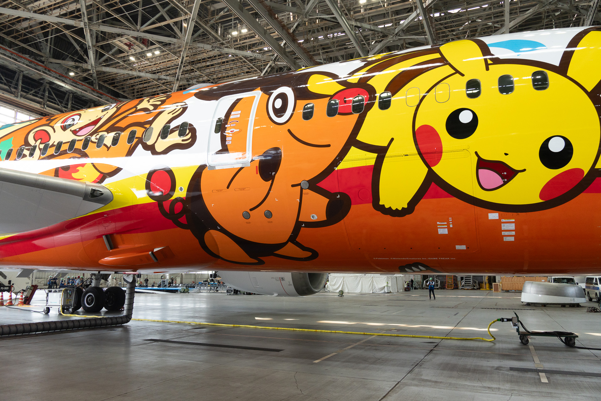 The right side of the "Pokémon Jet Red," from front to back: Pikachu, Tepig (Black/White), Chimchar (Diamond/Pearl), Scorbunny (Sword/Shield), Cyndaquil (Gold/Silver), and Litten (Sun/Moon).