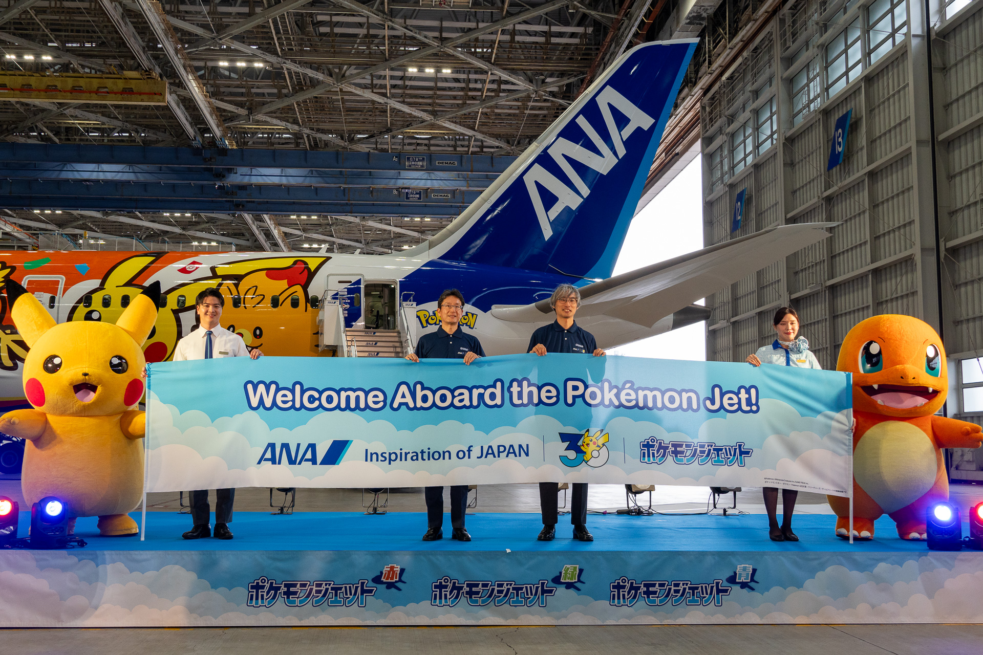 The "Pokémon Jet Red" will begin domestic service on July 29. Pictured are Keiji Omae, Executive Vice President of All Nippon Airways (center-left), and Takato Utsunomiya, Representative Director and COO of The Pokémon Company (center-right), who spoke at the ceremony.