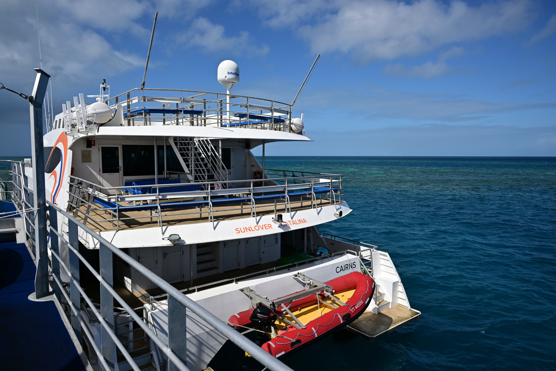 ポンツーンに接岸中のカタマランと、今回のツアーをアテンドいただいたSunlover Reef CruisesのASAMIさん