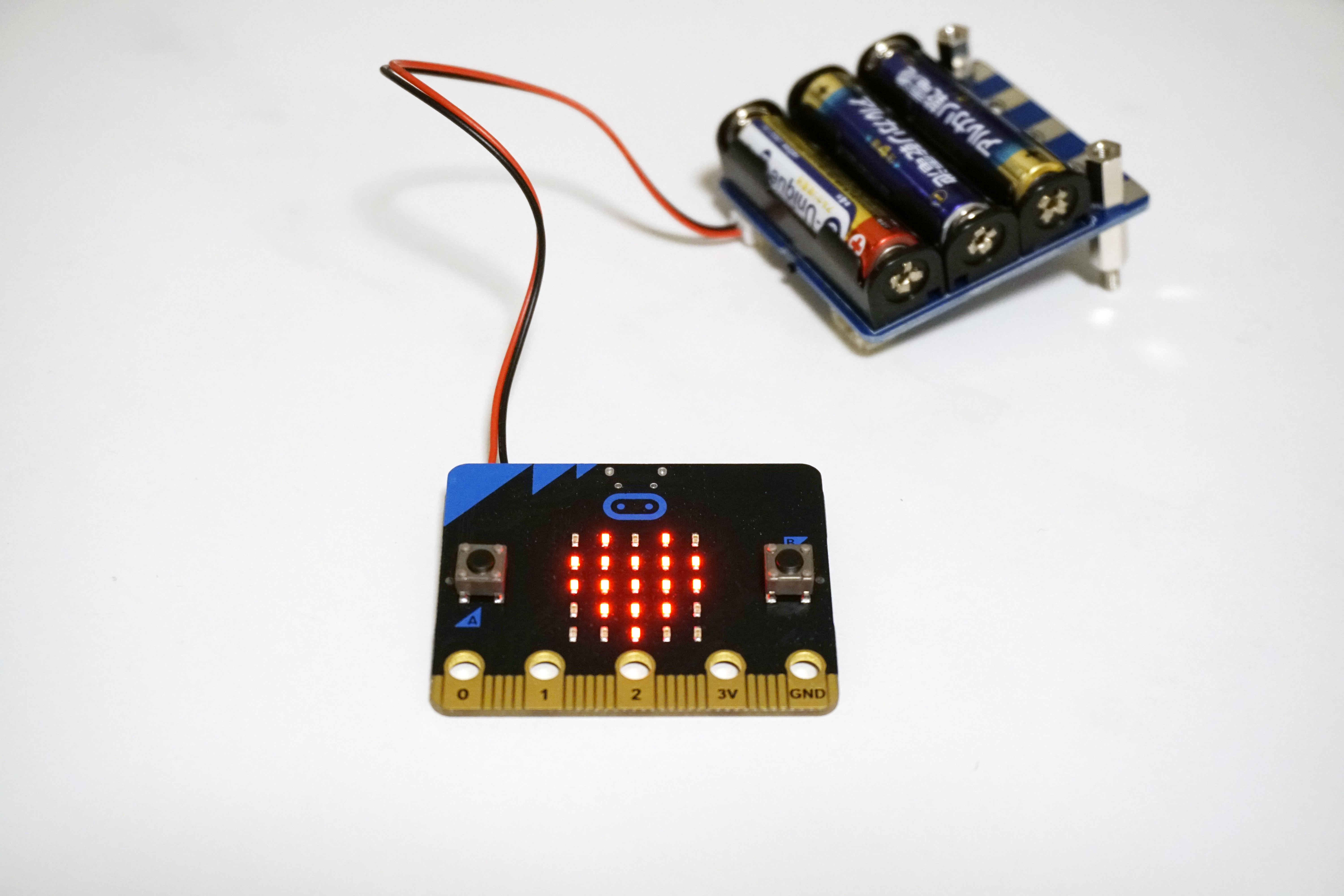 電池モジュールにつないだところ。わかりやすいようにねじ止めはしていない。パソコンと切り離して「micro:bit」単体でも、Aボタンを押すとハートマークが表示される